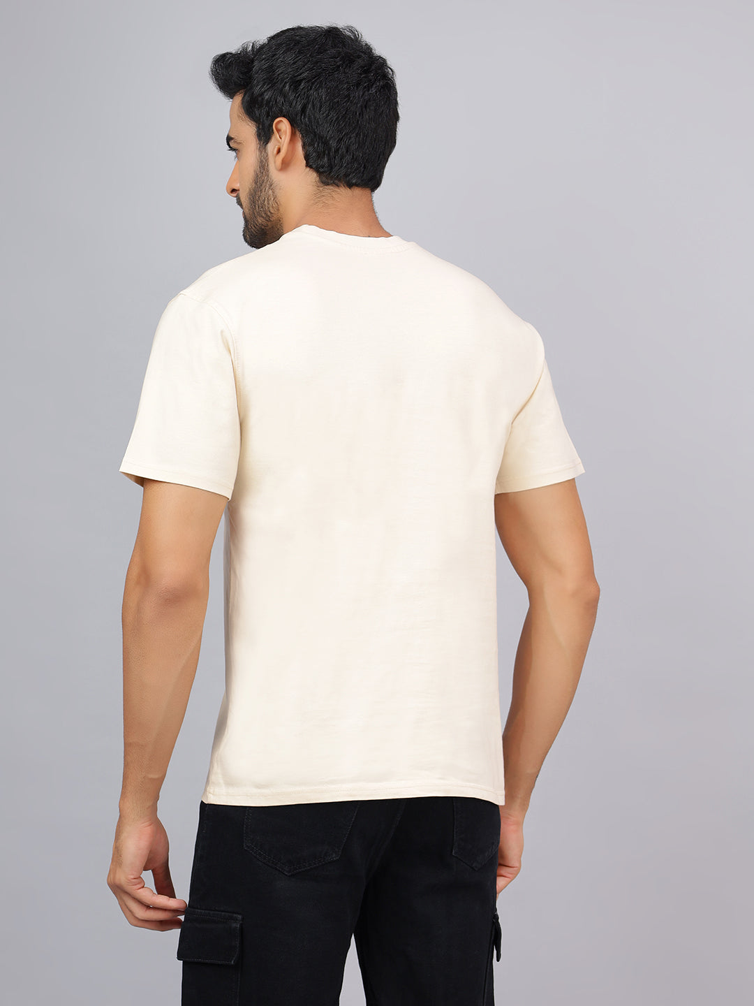 Man wearing a plain white t-shirt against a gray background