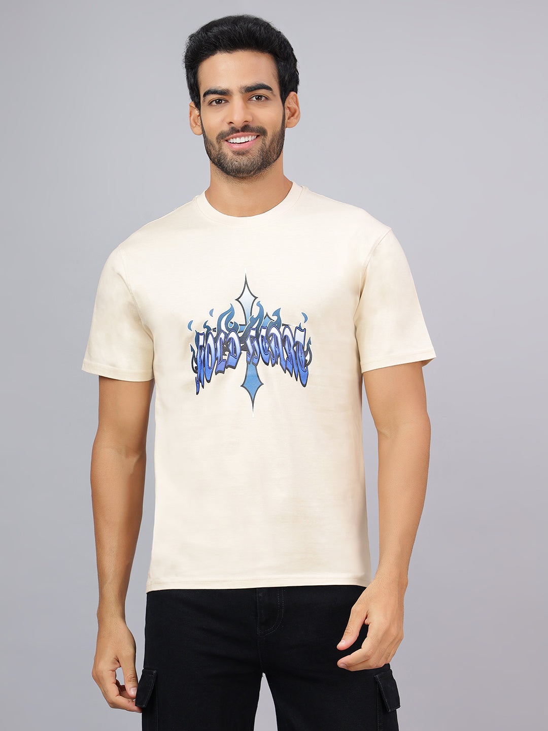 Man wearing a white t-shirt with blue graphic design on a gray background