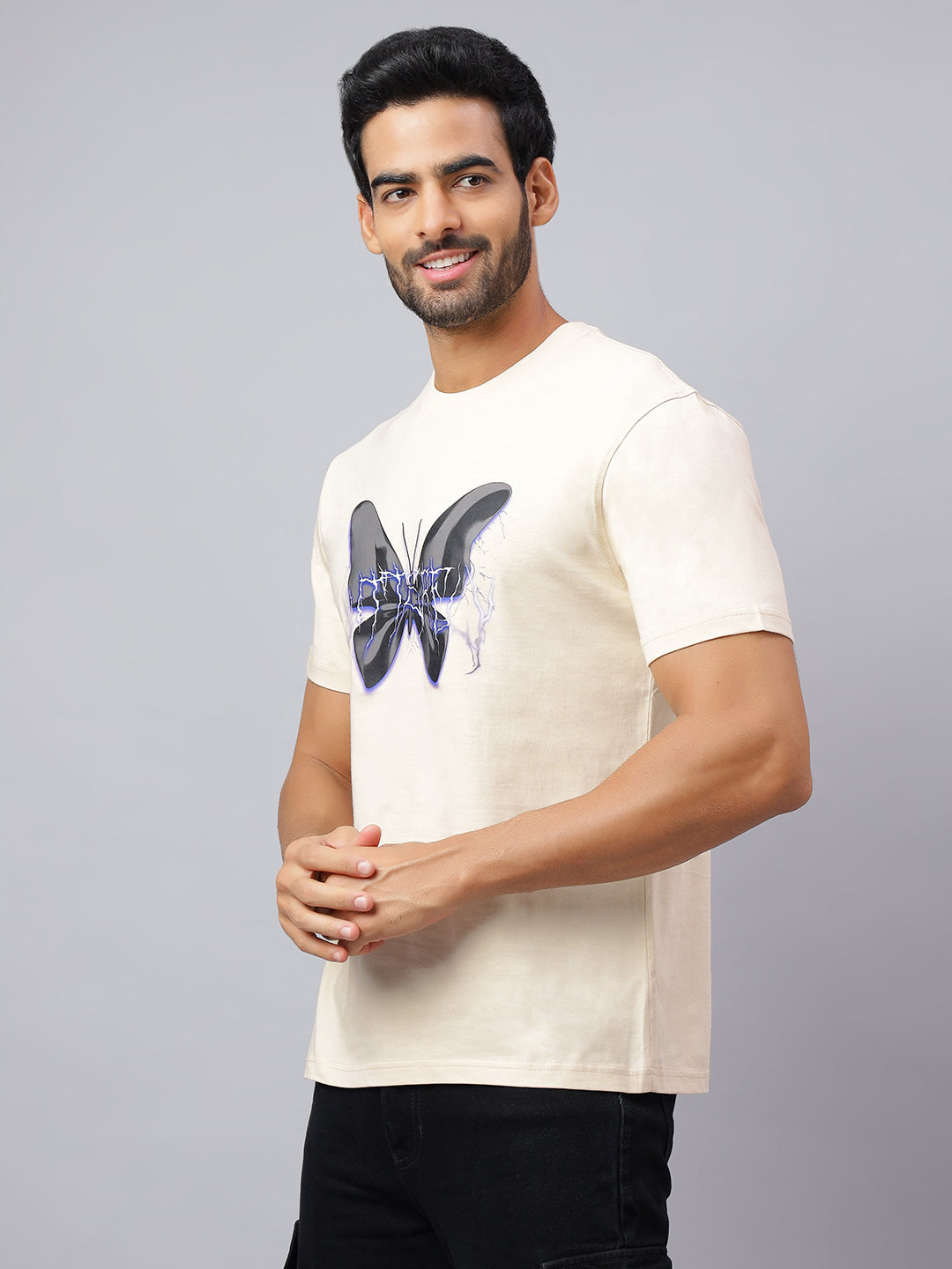 Man wearing a white t-shirt with a butterfly design on a gray background