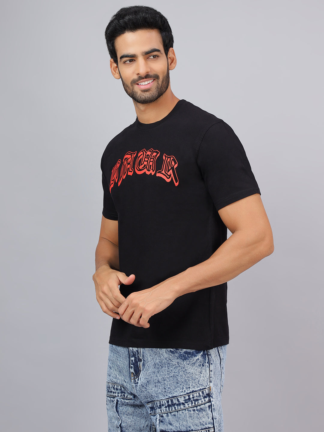 Man wearing a black t-shirt with red text on a gray background