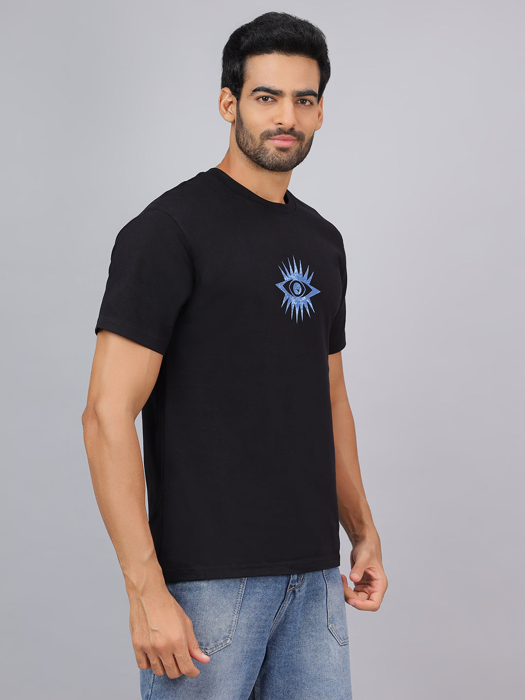 Man wearing a black t-shirt with a blue eye design on a gray background