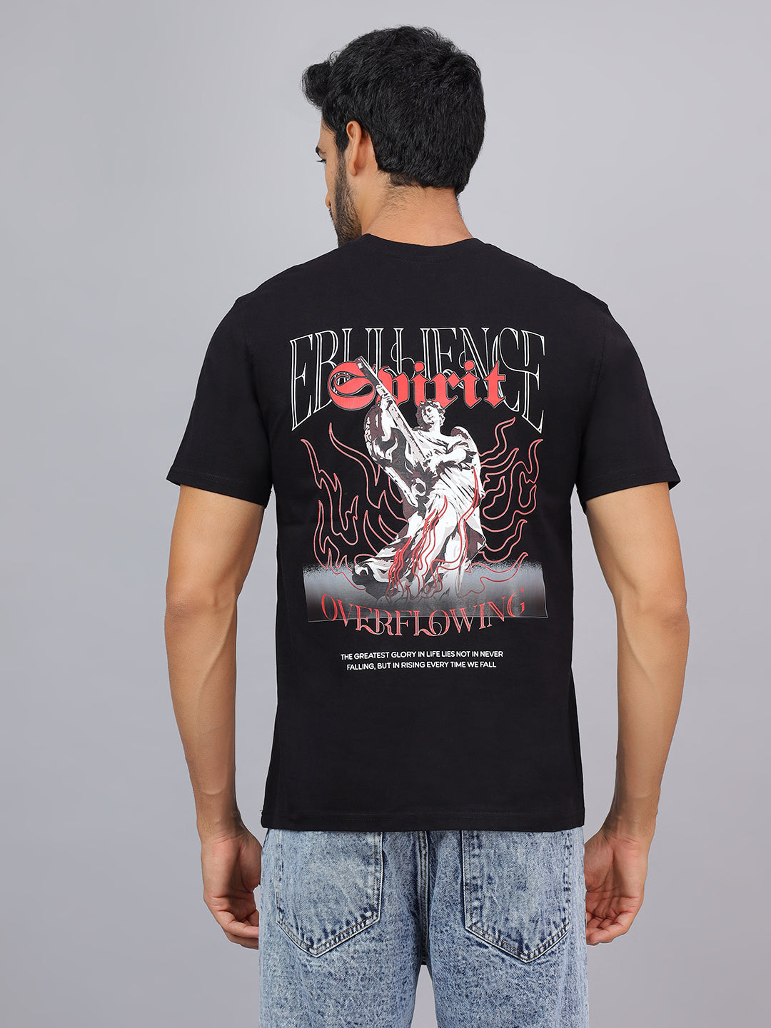 Person wearing a black t-shirt with graphic design on the back against a gray background