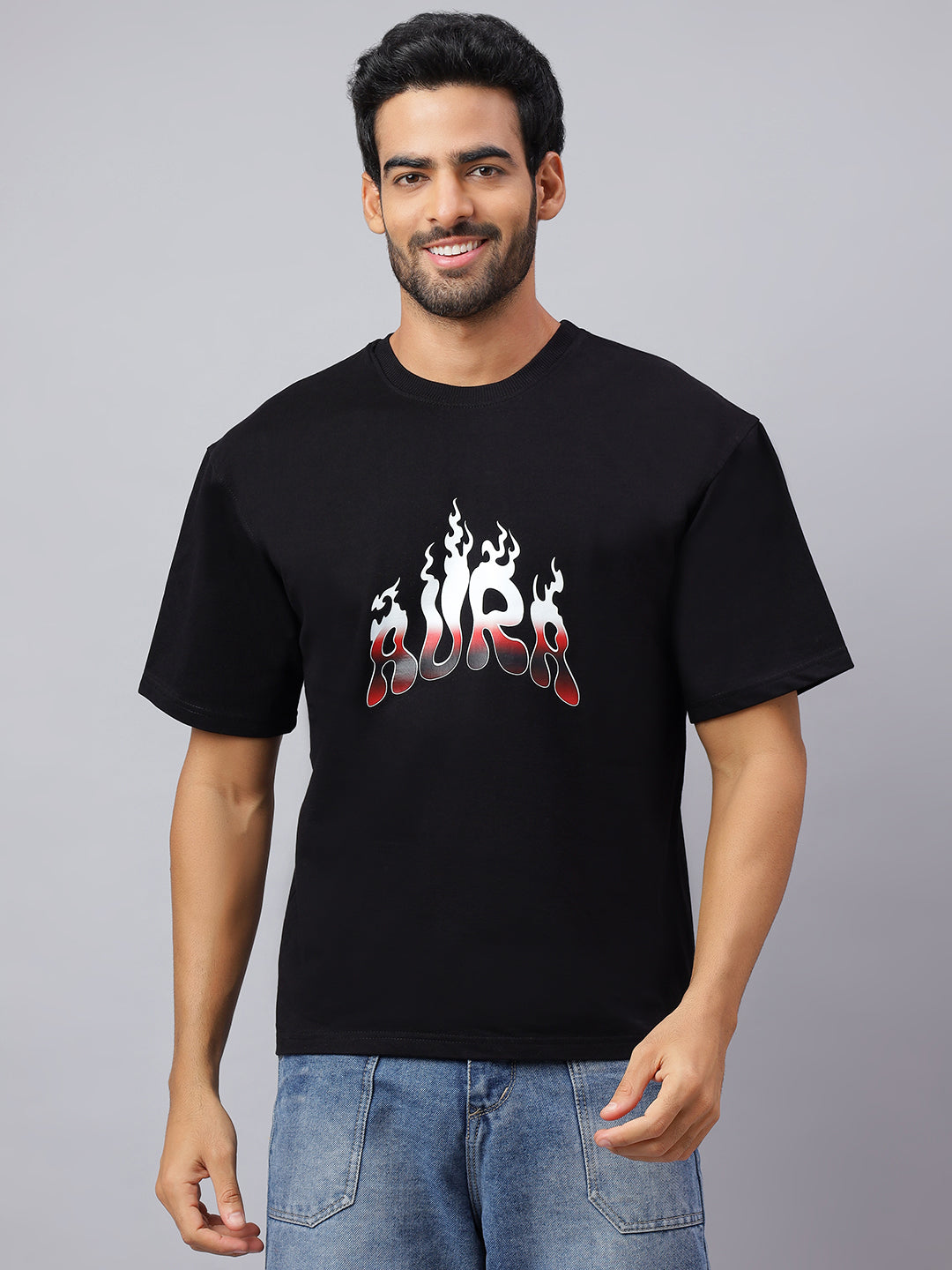 Man wearing a black t-shirt with a graphic design on a gray background