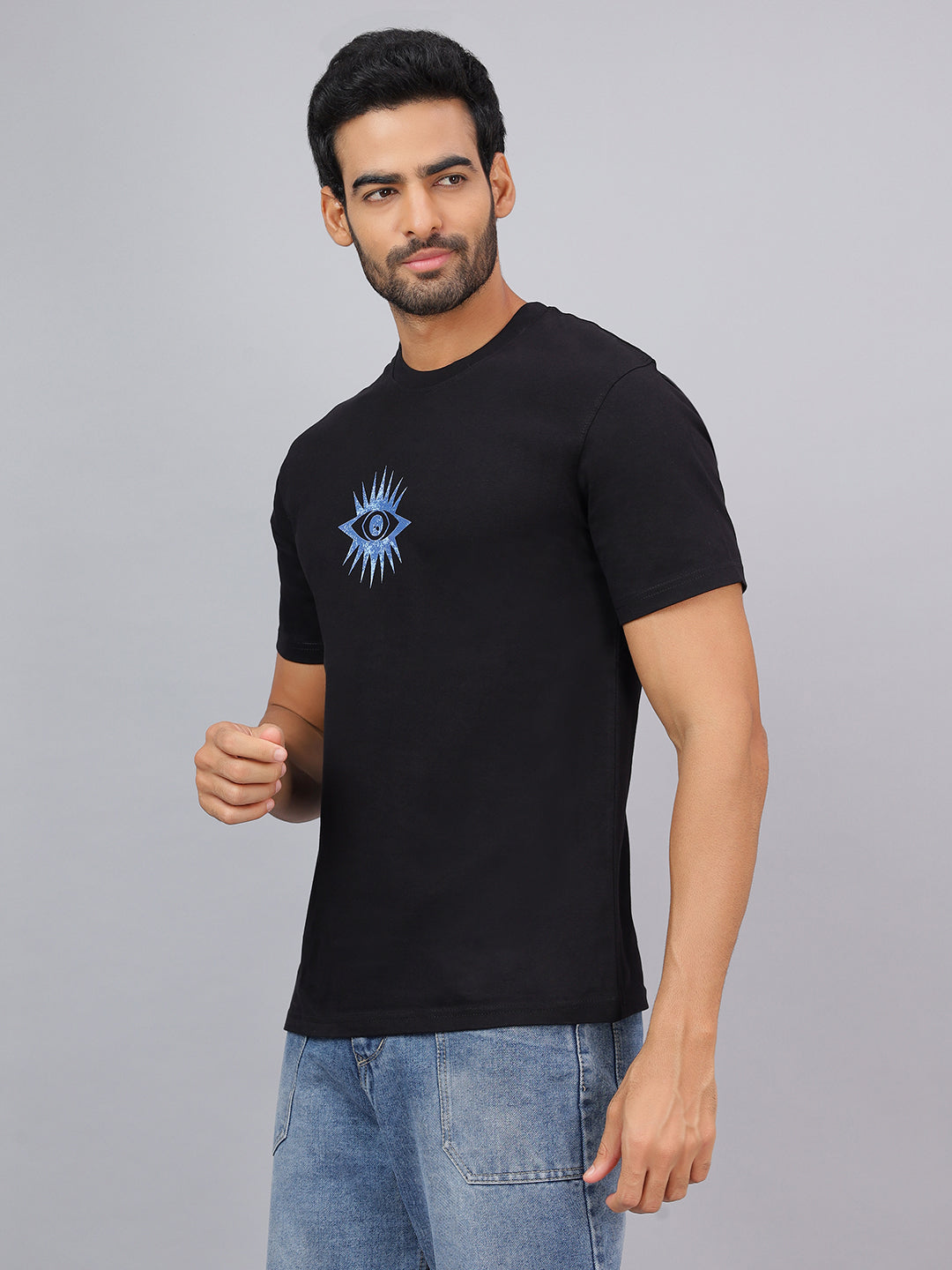 Man wearing a black t-shirt with a blue eye design on a gray background