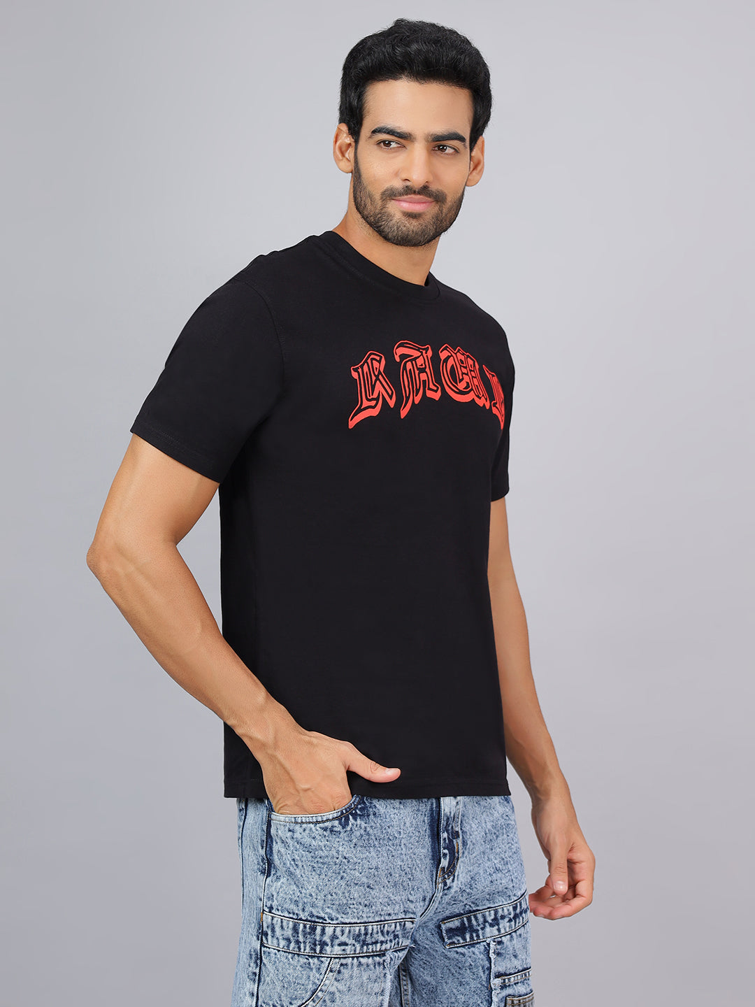 Man wearing a black t-shirt with red text on a gray background