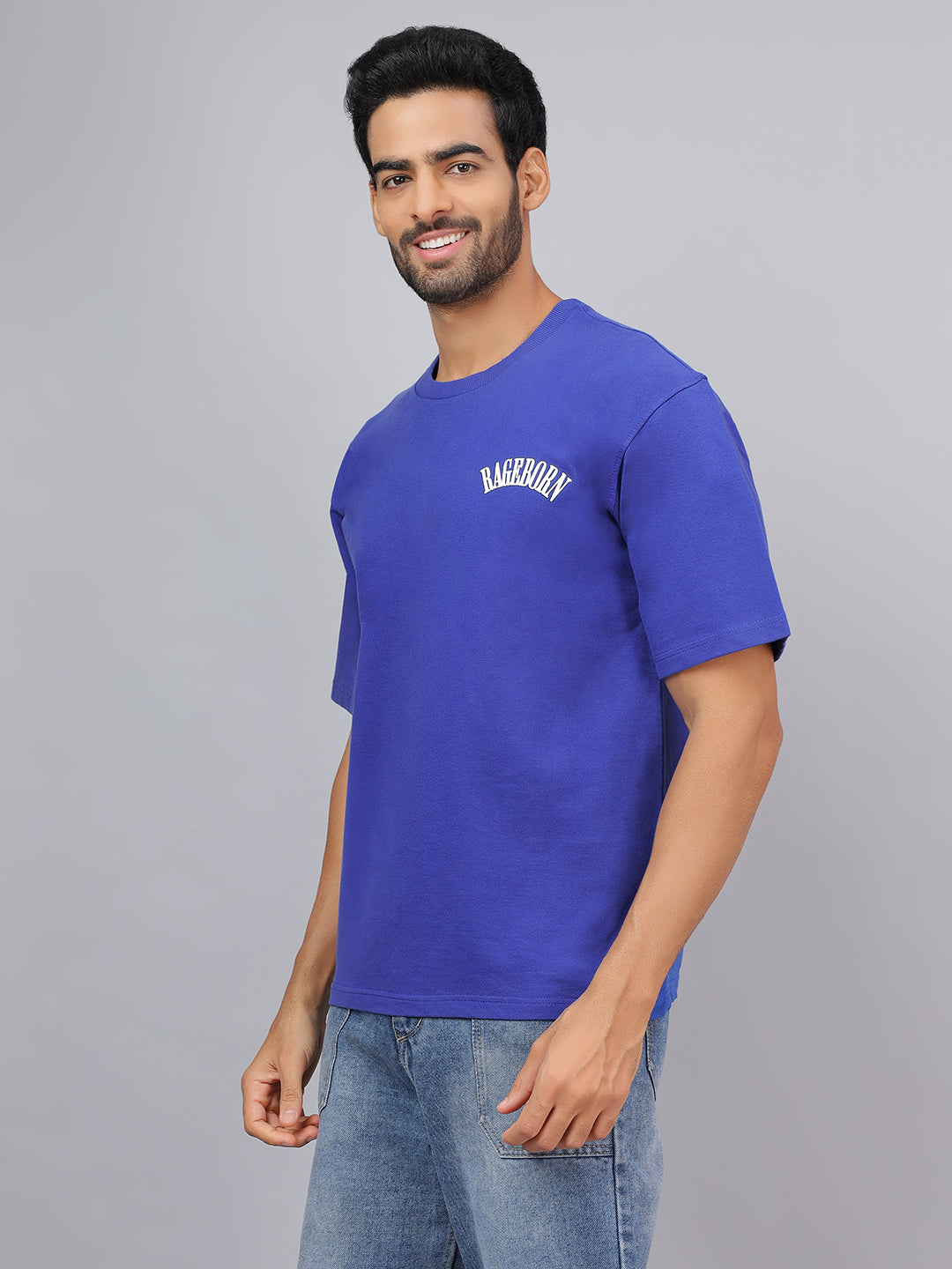 Man wearing a blue t-shirt with text on a gray background
