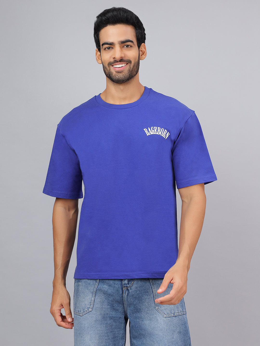 Man wearing a blue t-shirt with text on a gray background