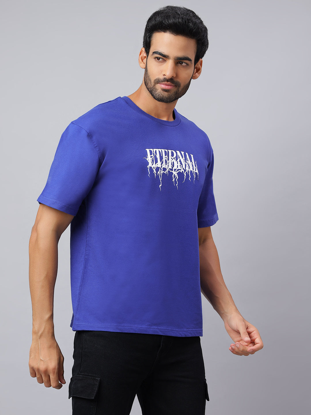 Man wearing a blue t-shirt with white text on a gray background