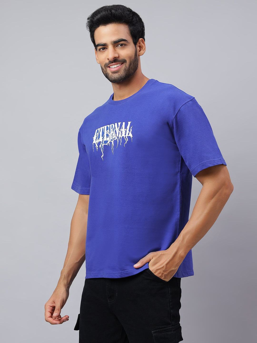 Man wearing a blue t-shirt with white text on a gray background