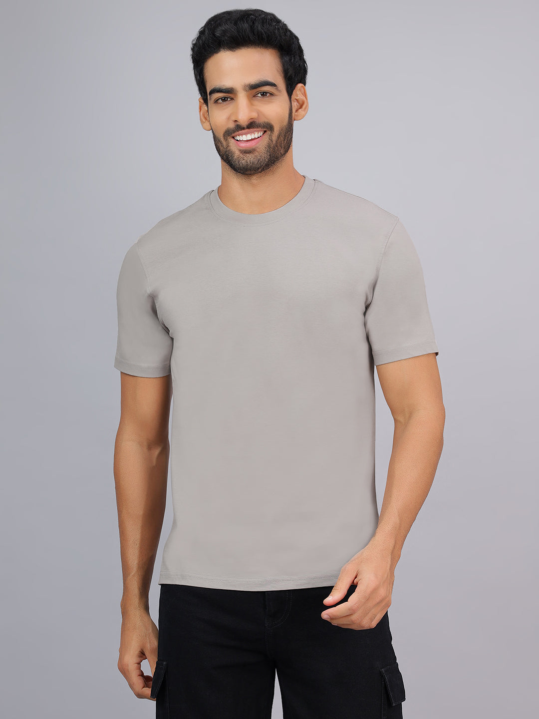 Man wearing a gray t-shirt against a plain background