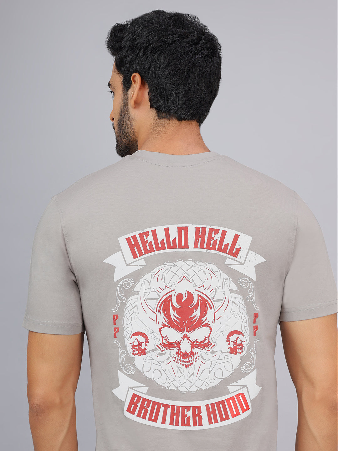 Man wearing a gray t-shirt with 'Hello Hell Brother Hood' design on the back.