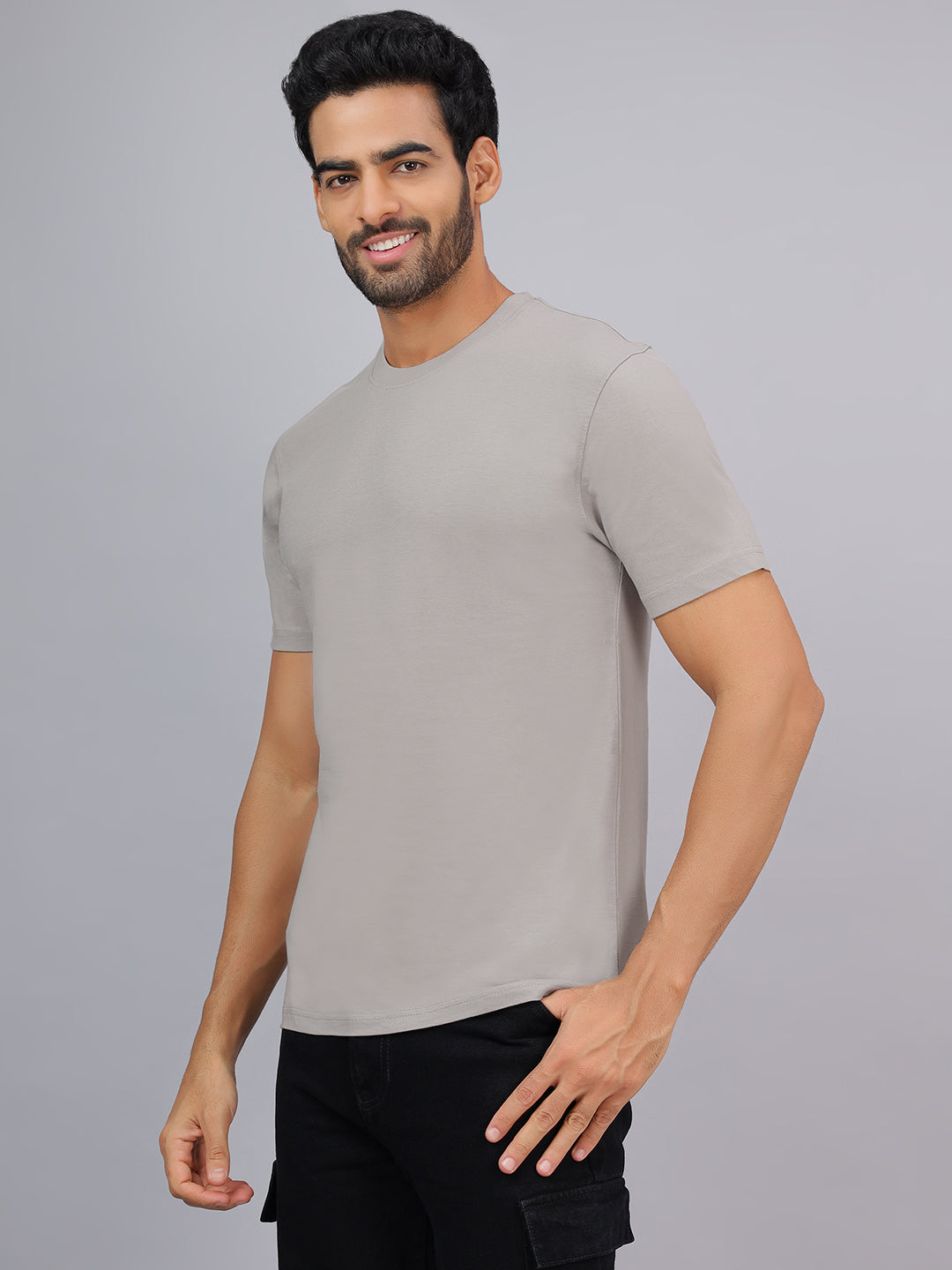 Man wearing a gray t-shirt against a gray background