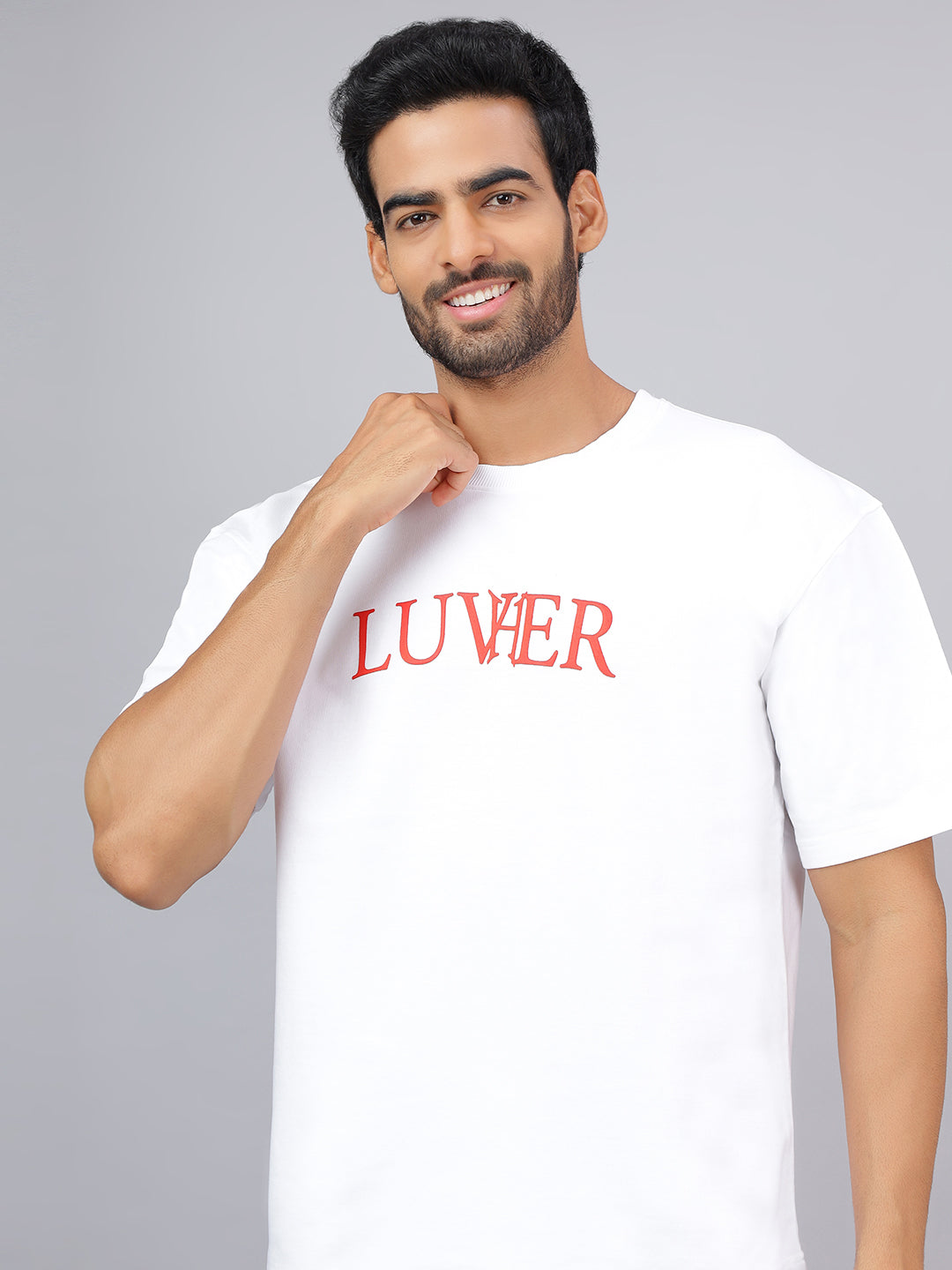 Man wearing a white t-shirt with 'LUVER' printed in red on a gray background
